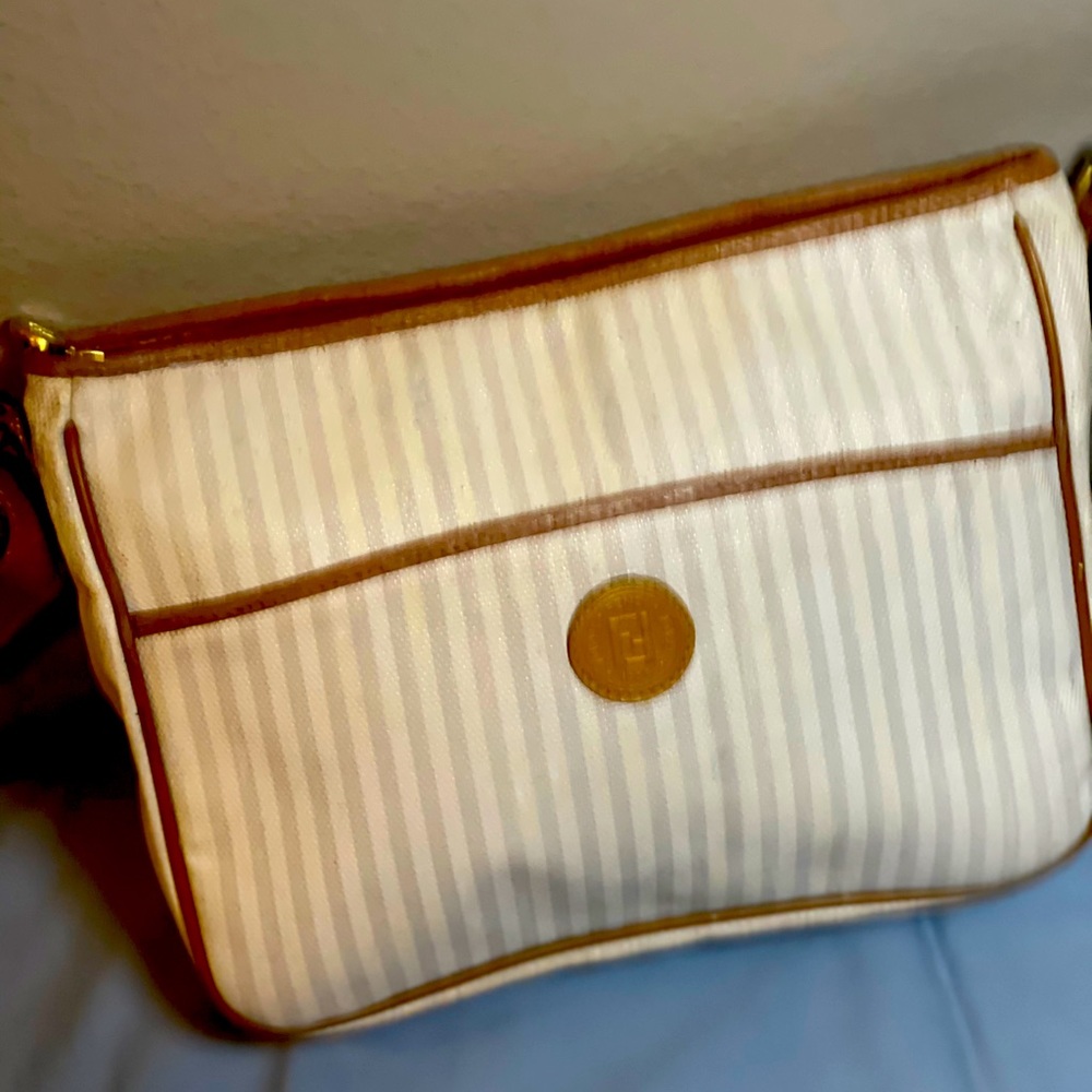 White Fendi crossbody bag.
